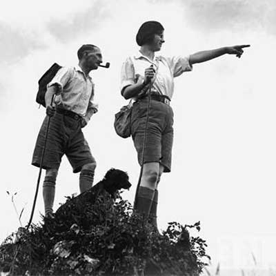A 1960s couple and their dog on a hike