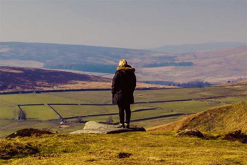 A person looking out over a wide view of the landscape