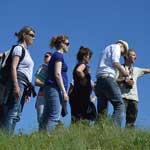 A group of five walkers at the top of a hill